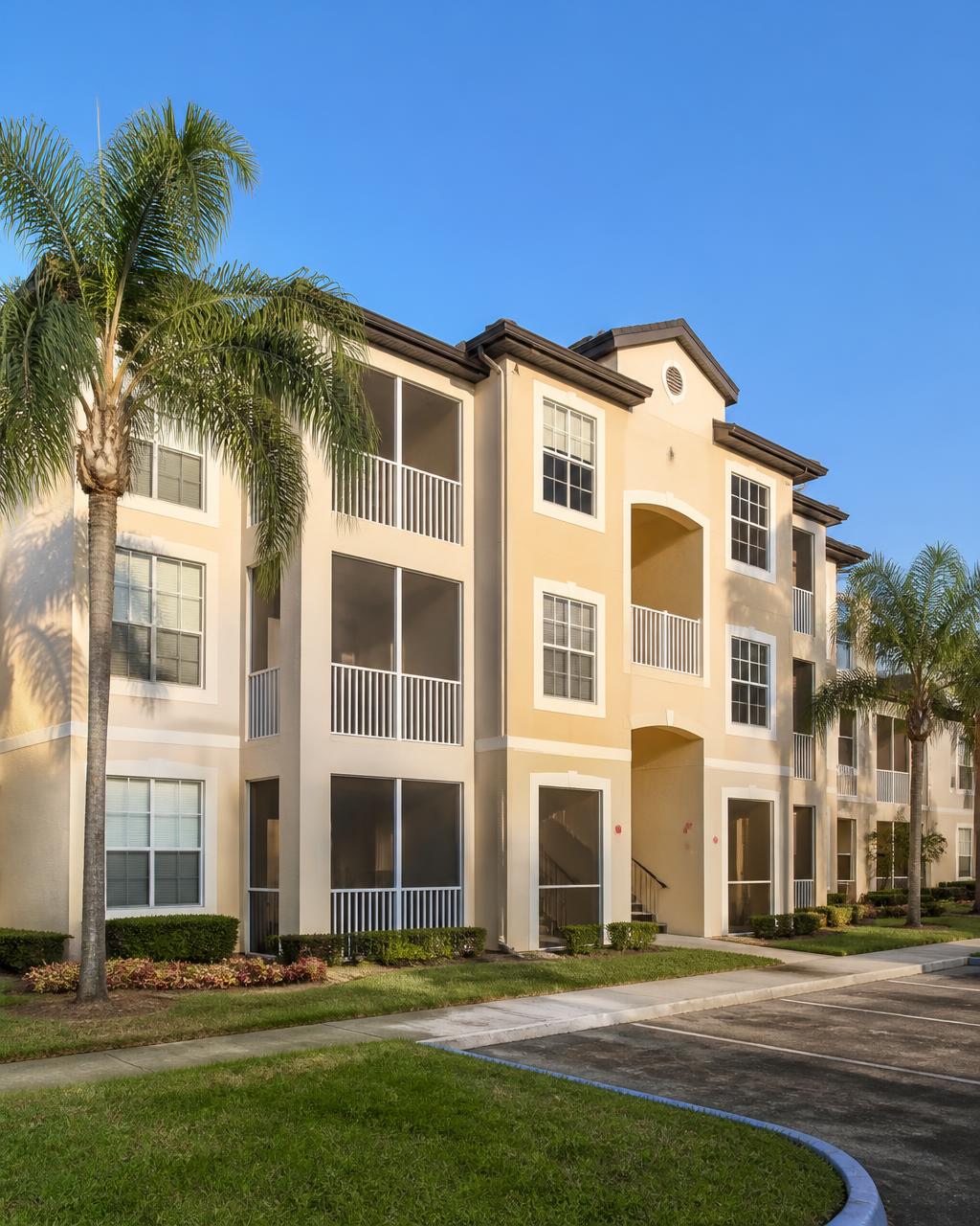 Freshly painted three-story condominium complex with balconies in Florida